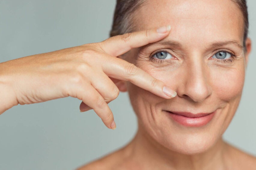 Closeup face of mature woman showing successful results after anti-aging wrinkle treatment.